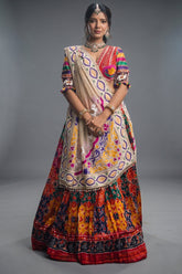 The Rajwadi Patola Silk Lehenga Ensemble With Scalloped V-Neck Hand-Embellished Blouse And Sheer Organza Tissue Dupatta