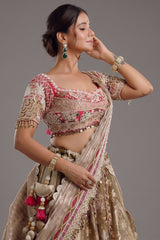 The Olive Green Shaded Brocade Silk Woven Lehenga Ensemble with Jharokha Embroidered Sweetheart Blouse and Attached Organza Dupatta