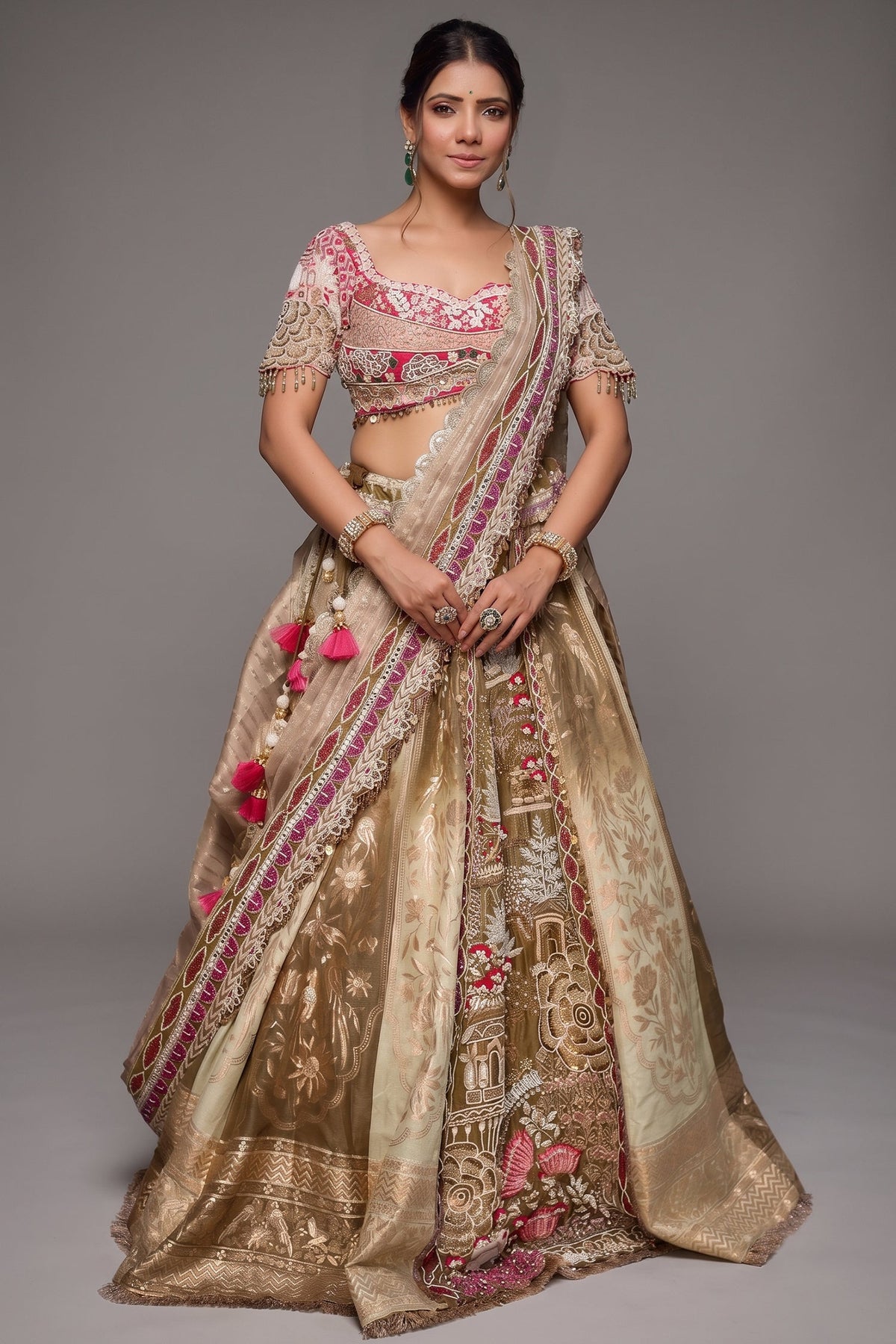 The Olive Green Shaded Brocade Silk Woven Lehenga Ensemble with Jharokha Embroidered Sweetheart Blouse and Attached Organza Dupatta
