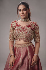 The Majestic Maroon Banarasi Silk Bridal Lehenga Ensemble with Jharokha Zardosi Blouse and Sheer Scalloped Veil