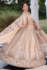 The Imperial Gold Jacquard Brocade Woven Silk Kalidar Lehenga Ensemble with Handcrafted Jewel Blouse and All-Over Cutwork Tissue Dupatta
