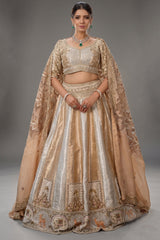 The Imperial Gold Jacquard Brocade Woven Silk Kalidar Lehenga Ensemble with Handcrafted Jewel Blouse and All-Over Cutwork Tissue Dupatta