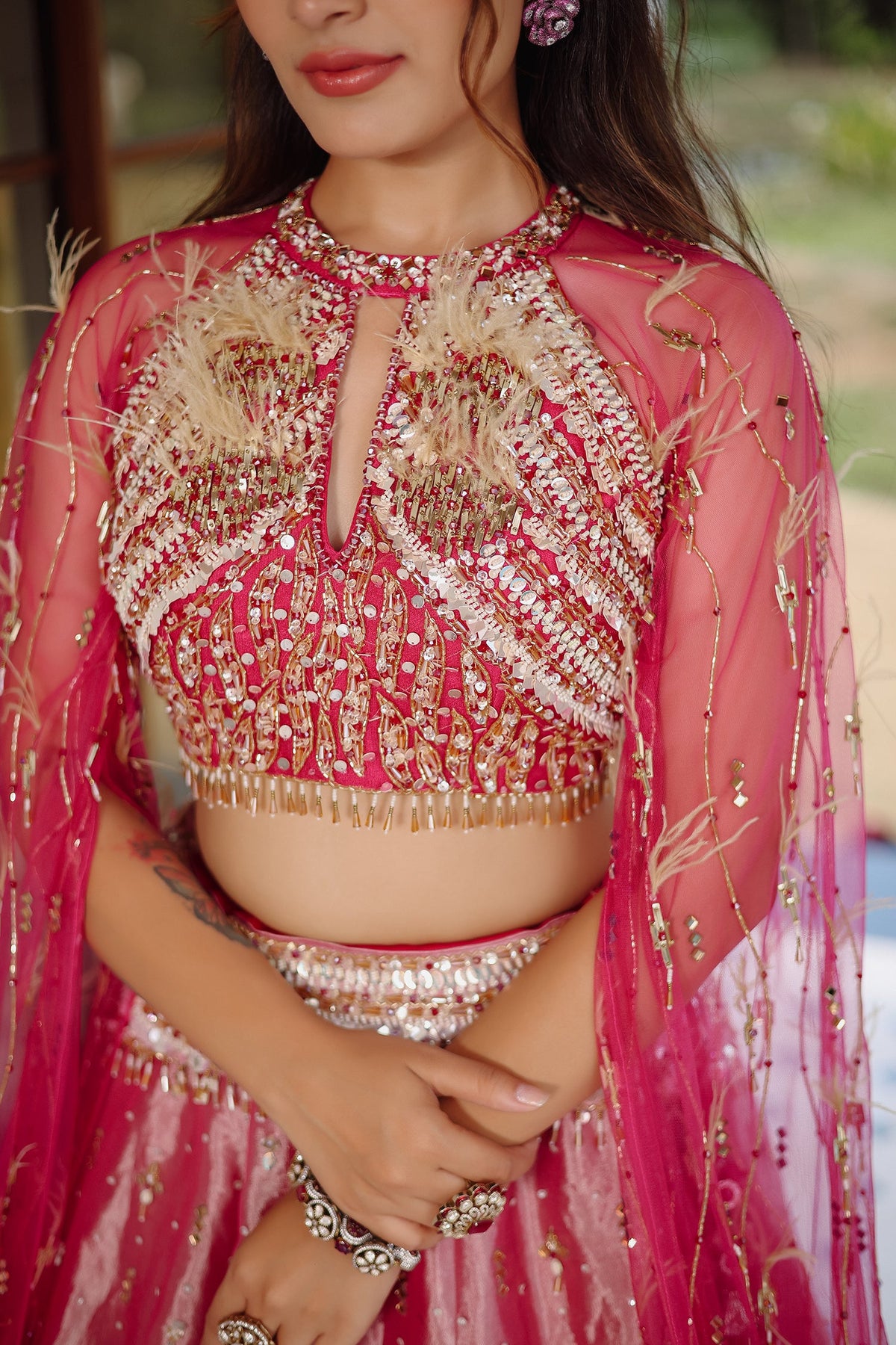 The Fuchsia Pink Ombre Tissue Lehenga Ensemble with High-Neck Keyhole Blouse and Floor-Length Feather Cape Sleeves