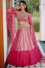 The Fuchsia Pink Ombre Tissue Lehenga Ensemble with High-Neck Keyhole Blouse and Floor-Length Feather Cape Sleeves