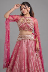 The Fuchsia Pink Ombre Tissue Lehenga Ensemble with High-Neck Keyhole Blouse and Floor-Length Feather Cape Sleeves
