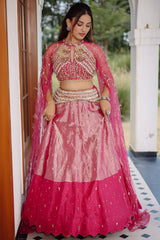 The Fuchsia Pink Ombre Tissue Lehenga Ensemble with High-Neck Keyhole Blouse and Floor-Length Feather Cape Sleeves