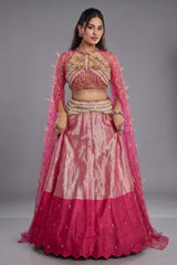 The Fuchsia Pink Ombre Tissue Lehenga Ensemble with High-Neck Keyhole Blouse and Floor-Length Feather Cape Sleeves