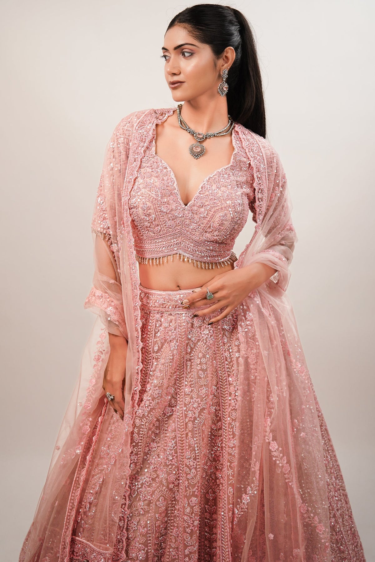 Blossom Pink Net Lehenga featuring Hand-Embellished V-Neck Blouse with Hanging Beads