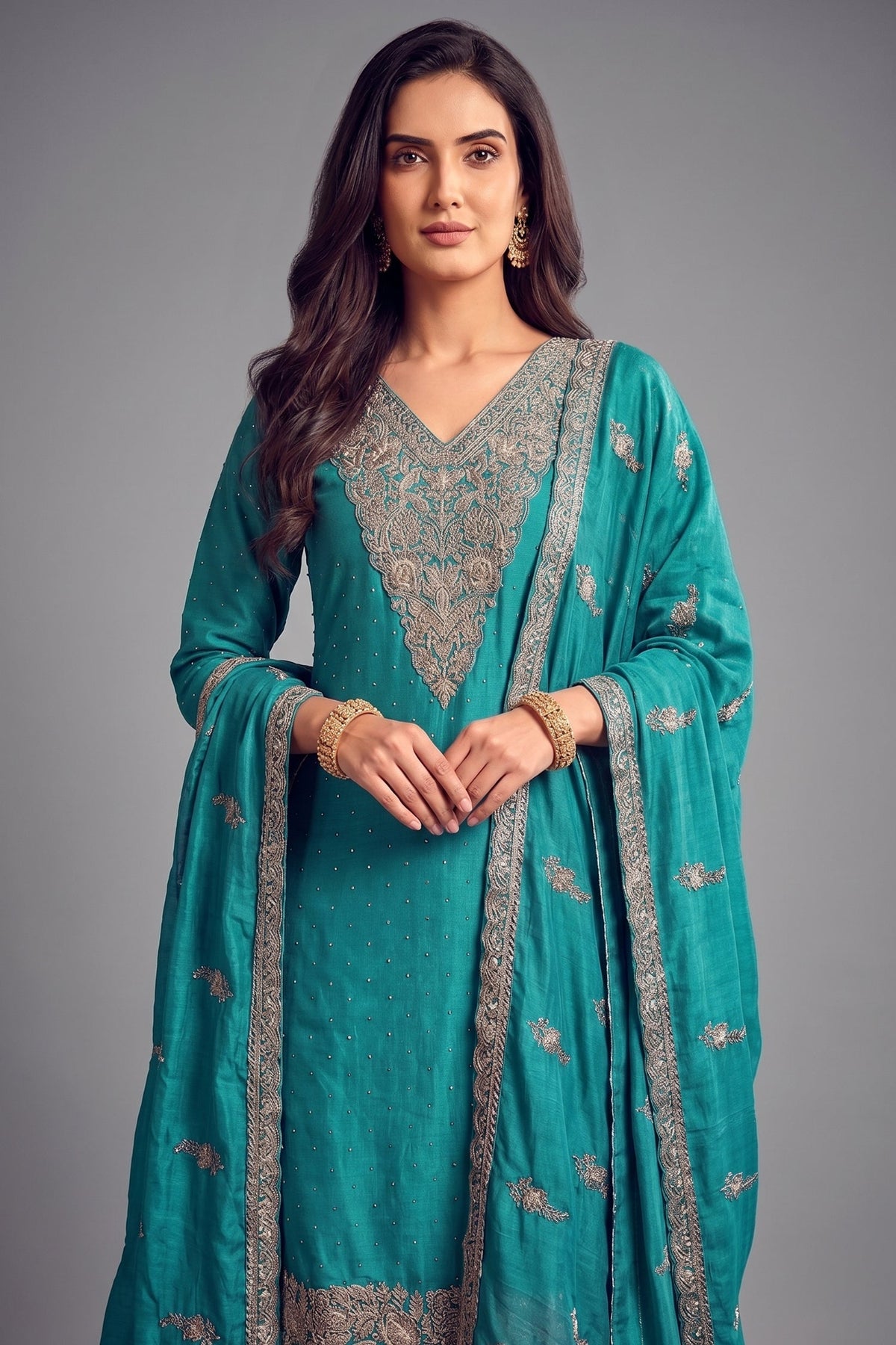 Close up of detailed floral embroidery on turquoise blue art silk suit kurta