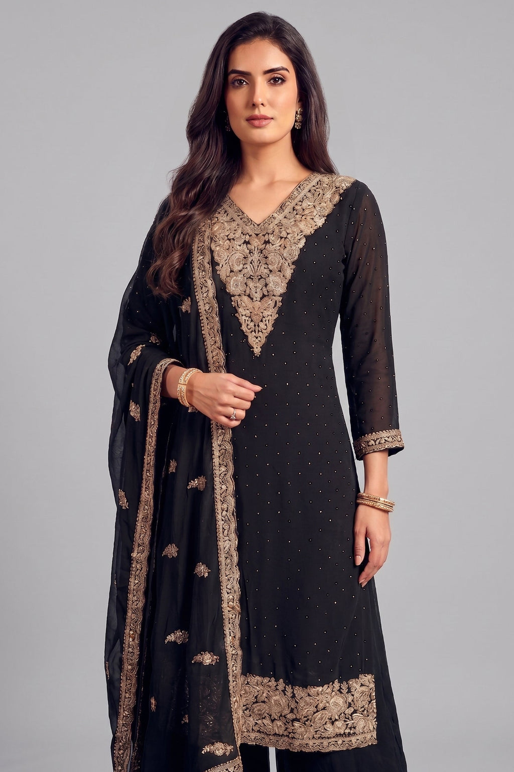 Close up of heavy antique silver embroidery on deep V neckline of black palazzo suit