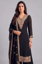 Close up of heavy antique silver embroidery on deep V neckline of black palazzo suit