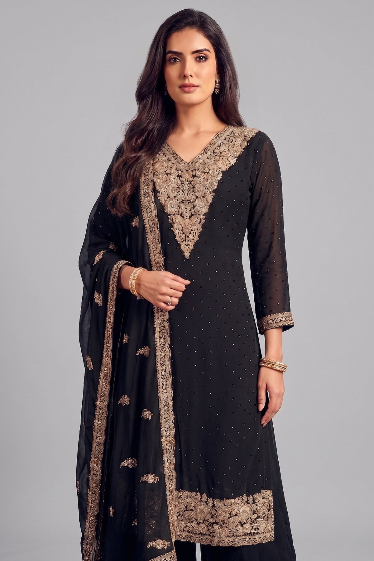 Close up of heavy antique silver embroidery on deep V neckline of black palazzo suit