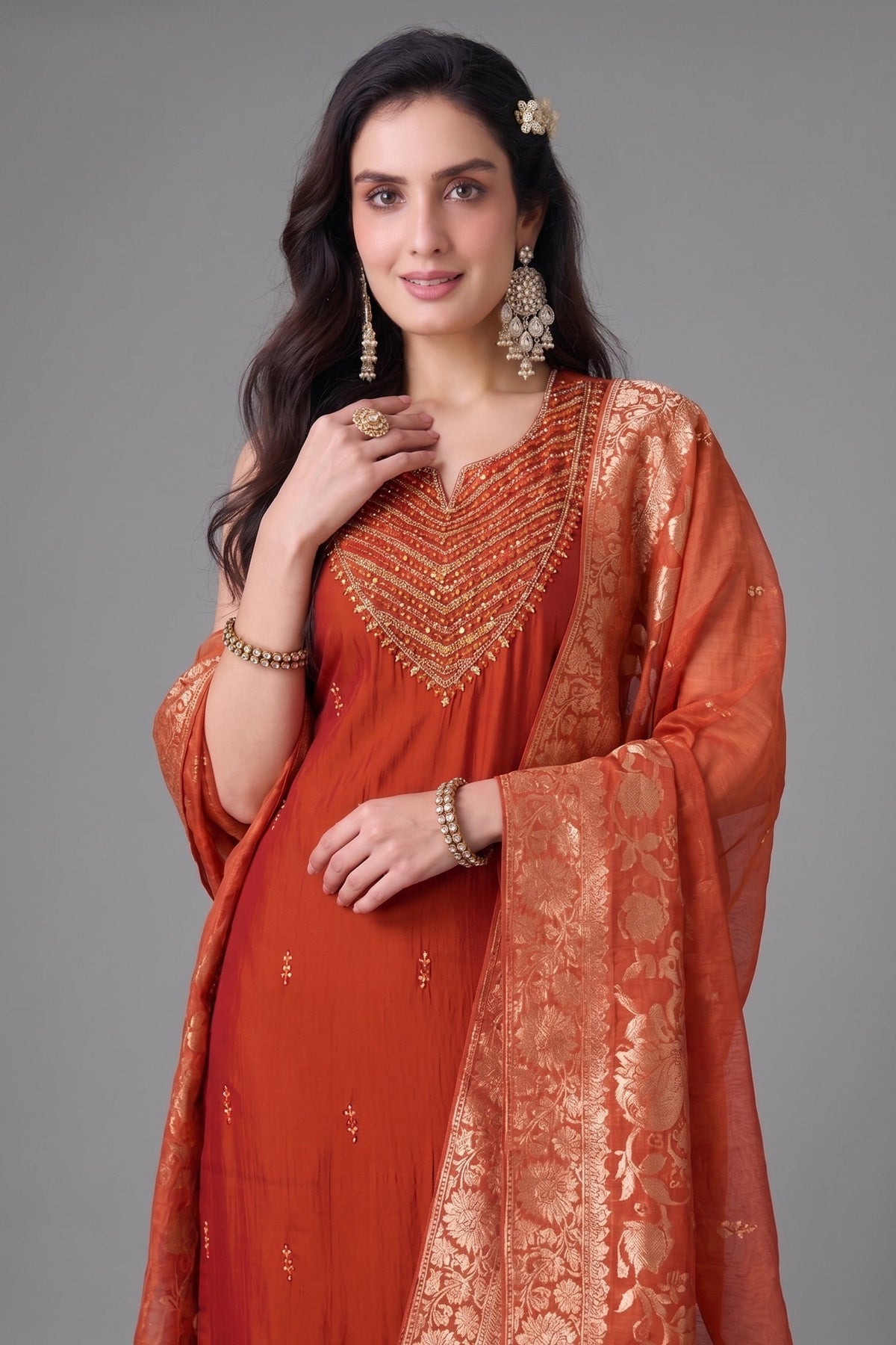 Close up of neckline mirror work embroidery on rust orange straight cut suit