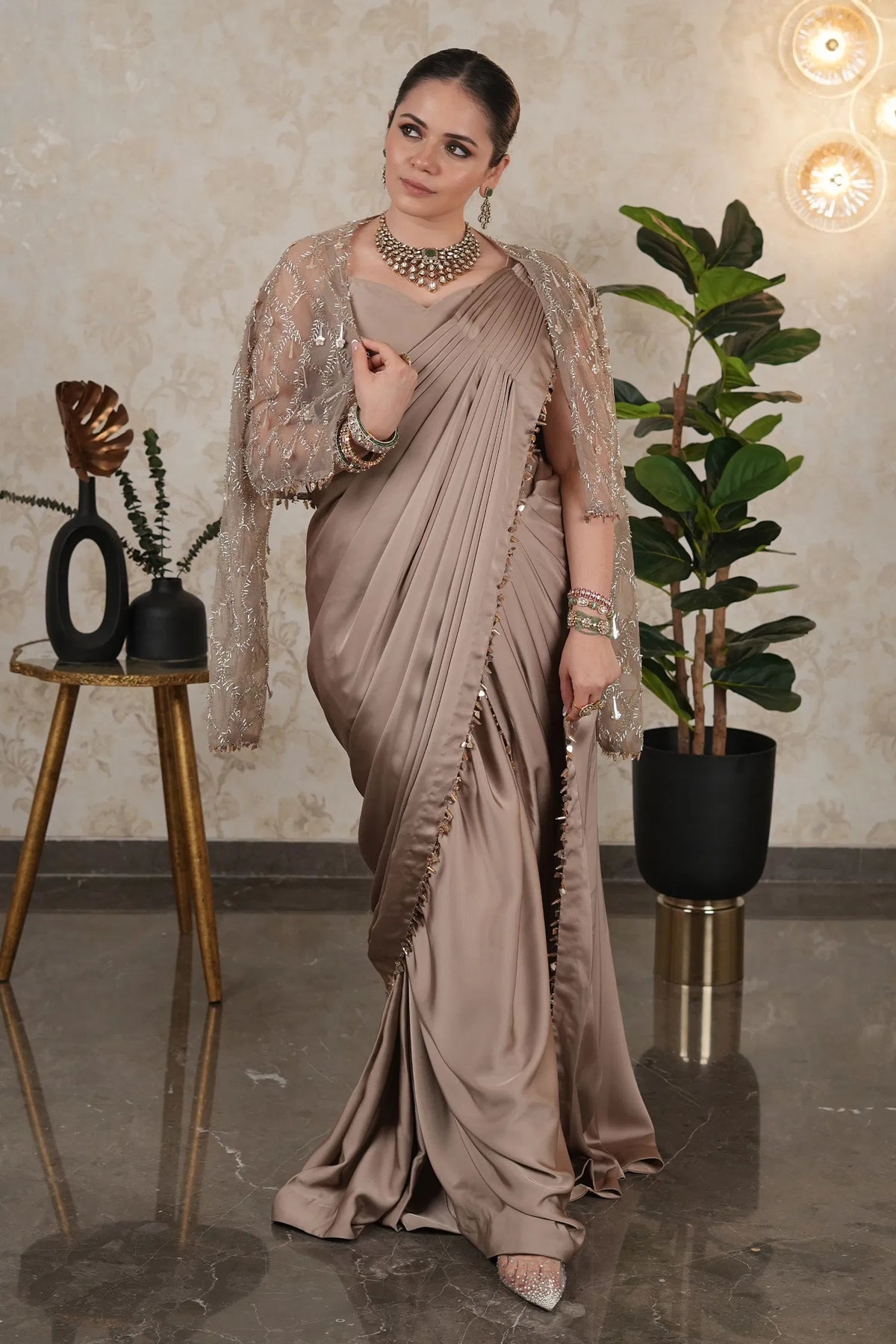 Taupe Satin Silk Pre Stitched Saree Featuring with a Narrow Embellished and Cutdana Short Cape Jacket